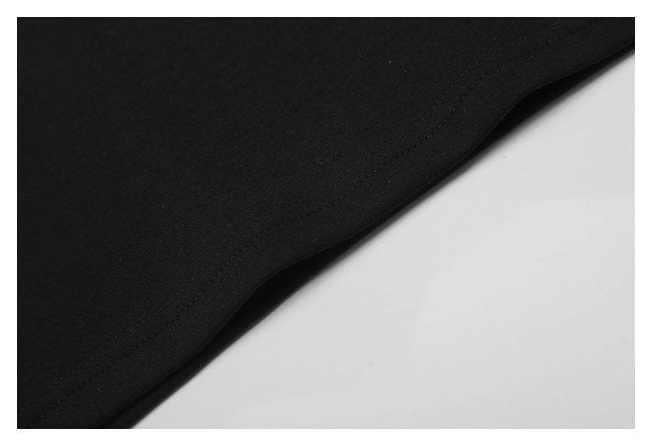 Close-up showing the double stitching along the hem of a black garment.