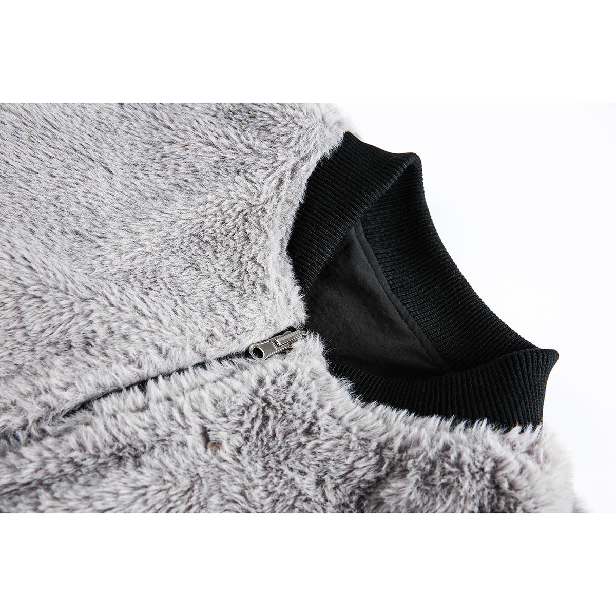 Close-up of a gray fuzzy jacket showing its black ribbed collar, dark lining, and metal zipper.