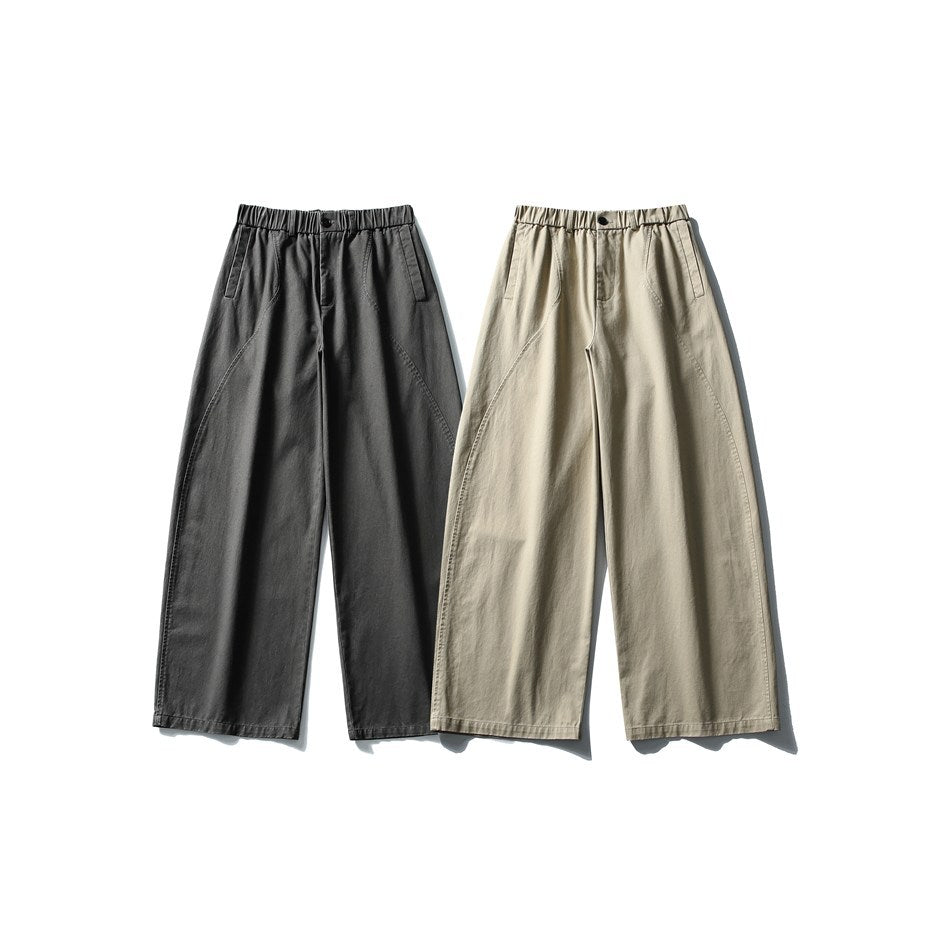 Front view of wide-leg trousers in charcoal and light beige, with elastic waists and slanted pockets.
