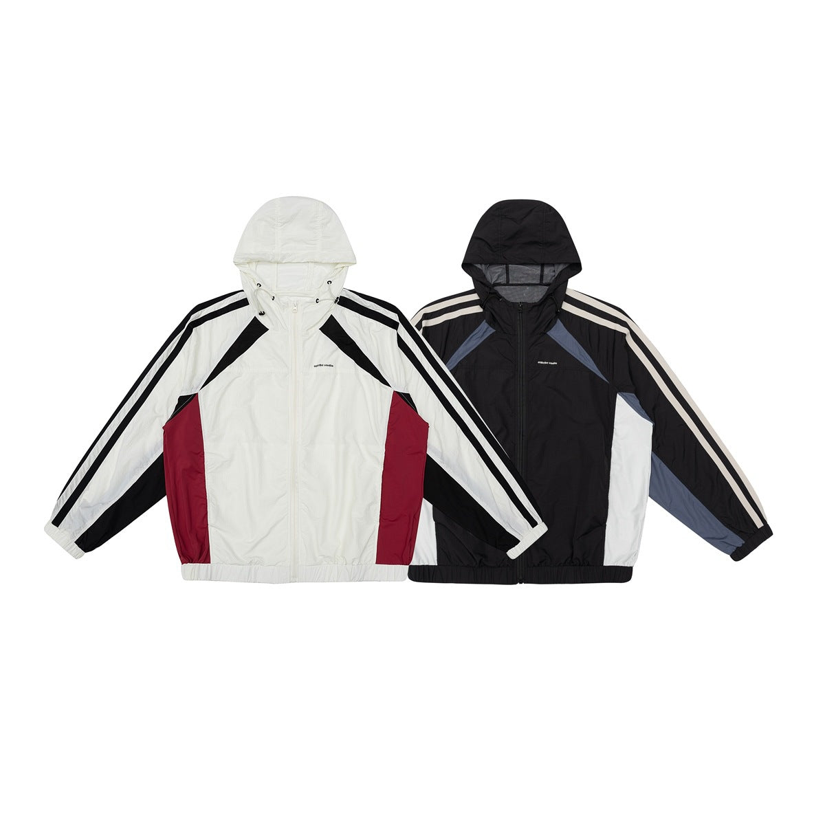 Two hooded color-block jackets shown from the front: ivory, black and burgundy; and black, white and slate blue.