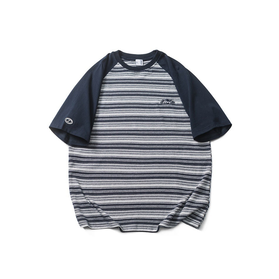 Navy raglan-sleeve T-shirt with fine navy, white and gray horizontal stripes and a small chest patch, front view