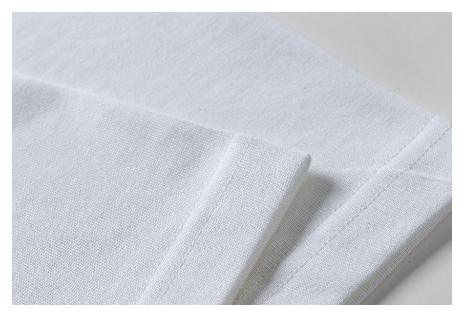 Close-up of the white T-shirt's stitched hem and fabric.