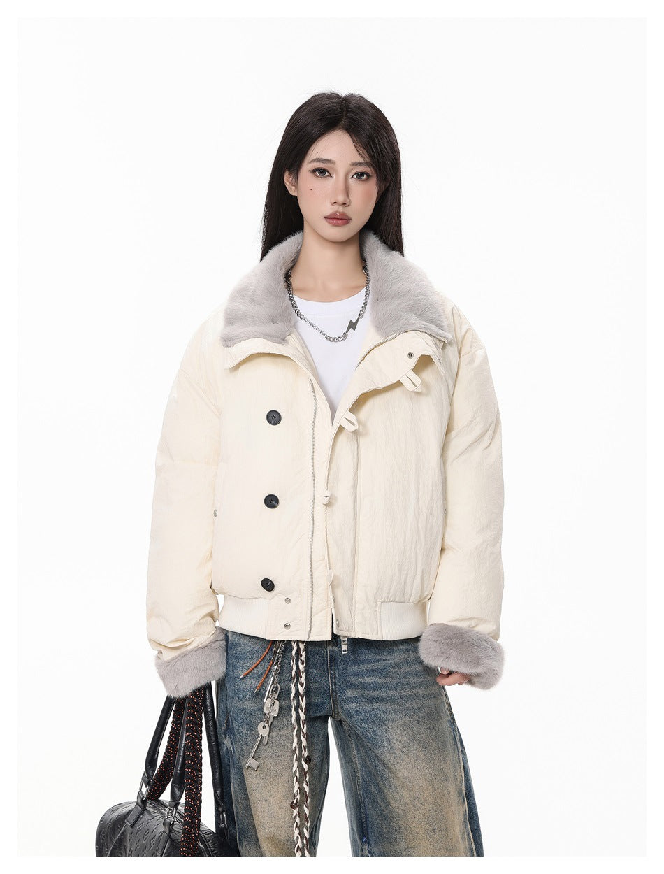Close view of a model in the cream jacket with gray fleece-like collar and cuffs, showing buttons, zip and ribbed hem