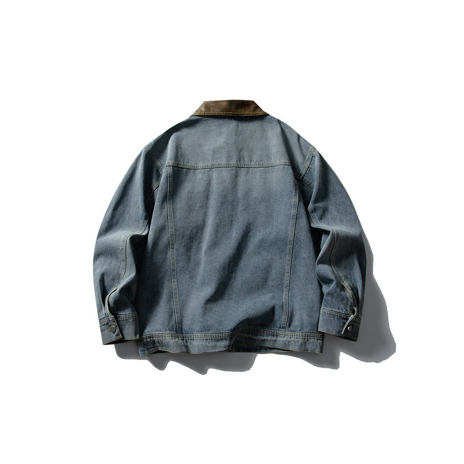 Back of a blue washed denim jacket with brown collar, back yoke seam, banded hem and buttoned cuffs