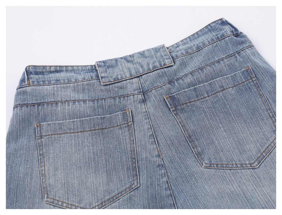 Close-up of the back of faded blue jeans, showing the waistband and two patch pockets.