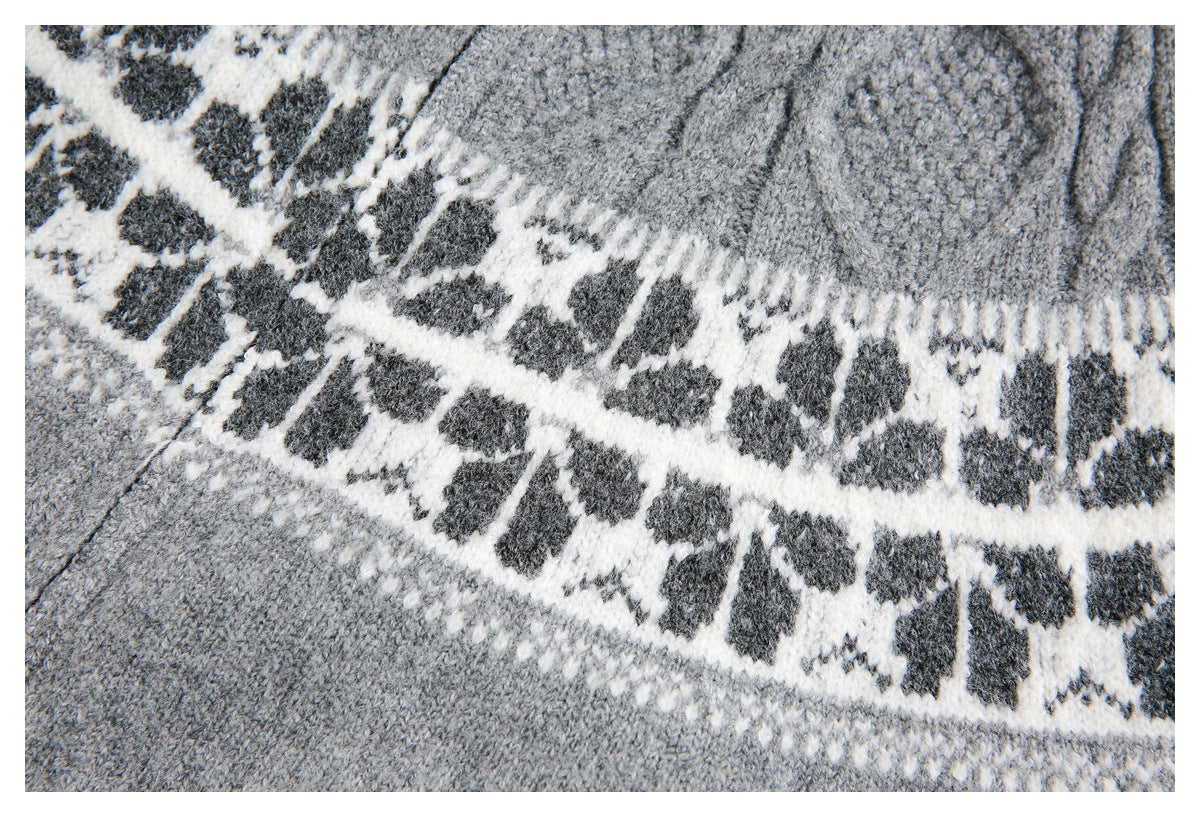 Close-up of a gray knit garment with a cream and charcoal geometric pattern.