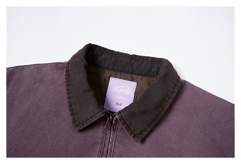 Close-up of the jacket's dark brown collar, front zipper, and interior neck label.