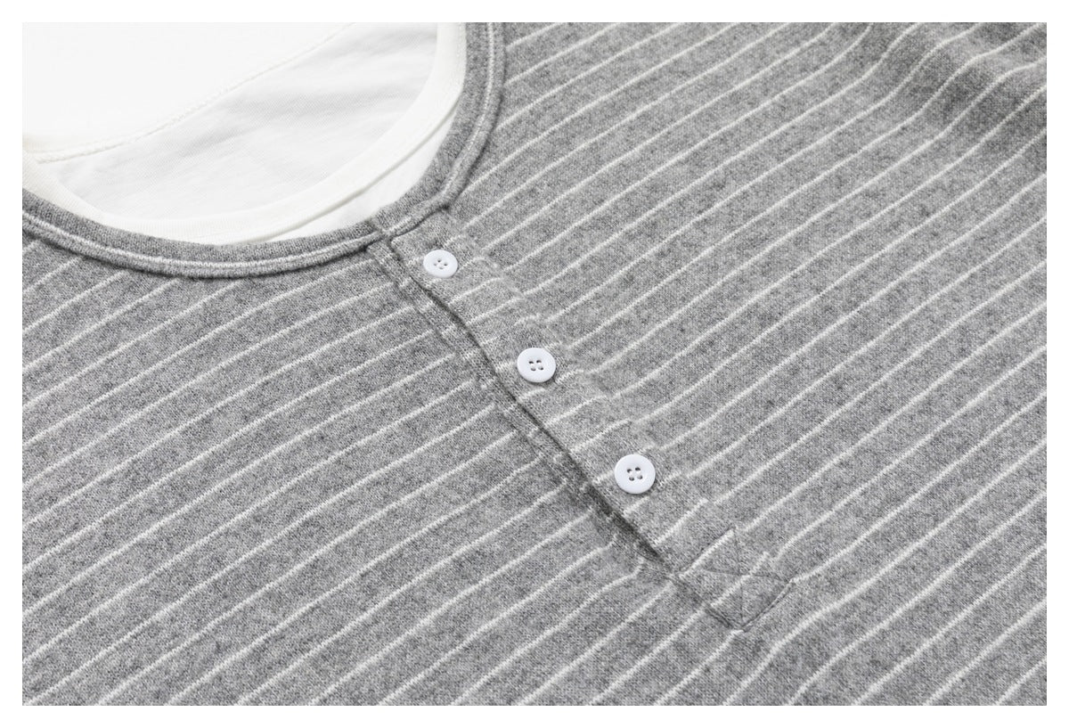 Close-up of a gray-and-white striped shirt neckline and three-button placket.