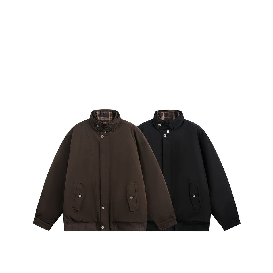 Two front views of the same raised-collar jacket in dark brown and black, each with buttoned pockets and plaid collar lining.