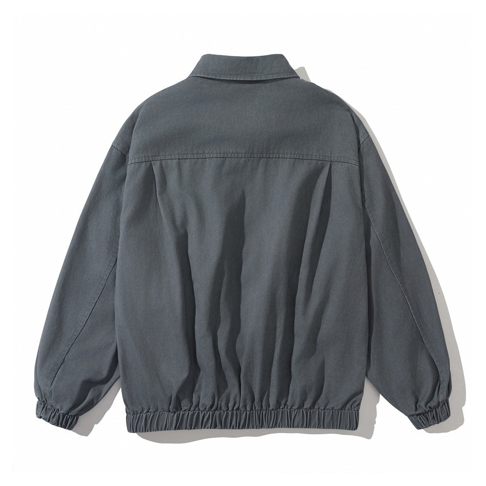 Back view of gray washed jacket showing yoke seam, gathered fullness, collar, long sleeves and elastic cuffs and hem
