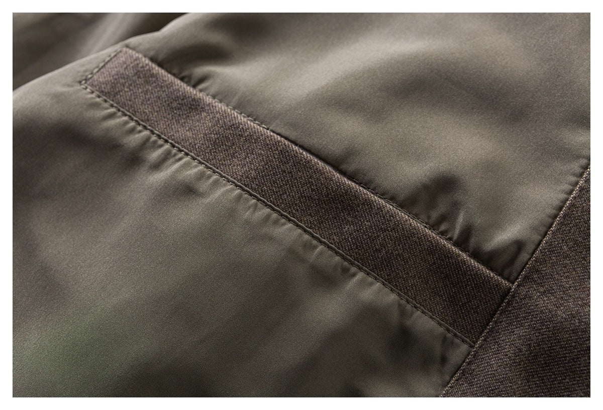 Close-up of a smooth dark lining beside a stitched strip of textured brown-gray fabric.
