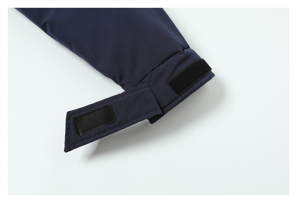 Close-up of a dark navy sleeve cuff with an adjustable hook-and-loop strap.