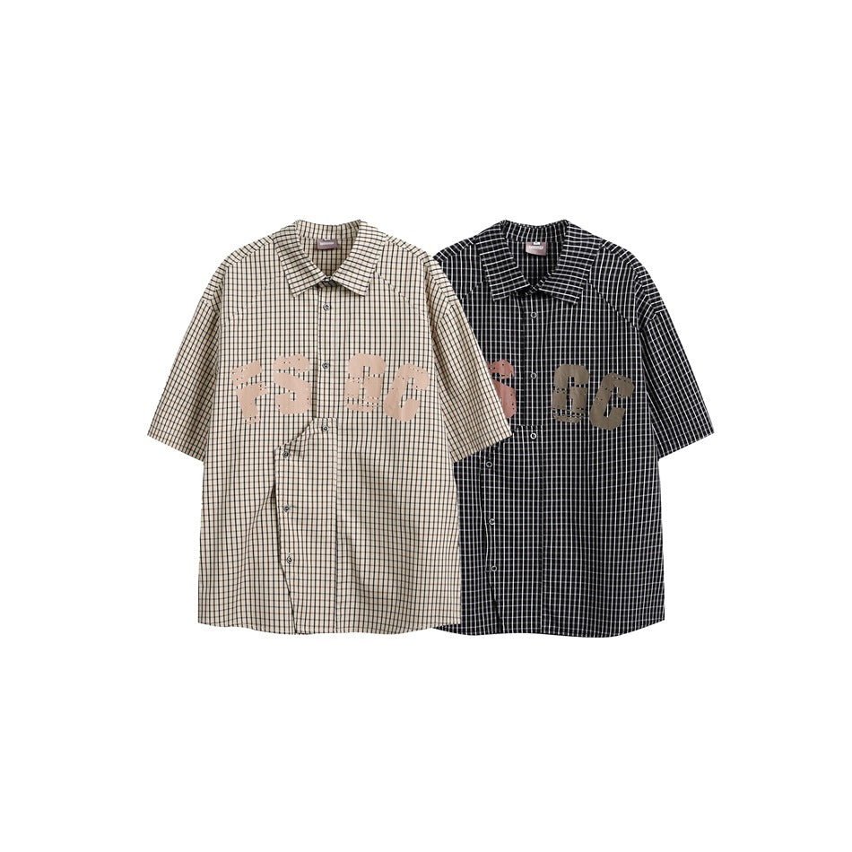 Two short-sleeve checked button-up shirts shown from the front in beige and black, both with chest graphics.
