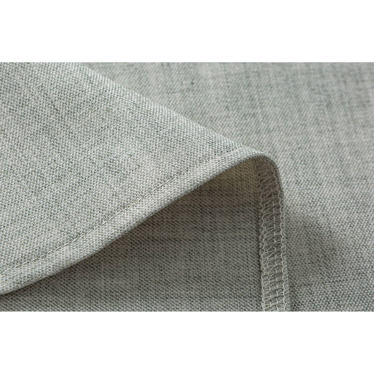 Close-up of light gray shirt fabric showing a folded edge and overlocked seam.