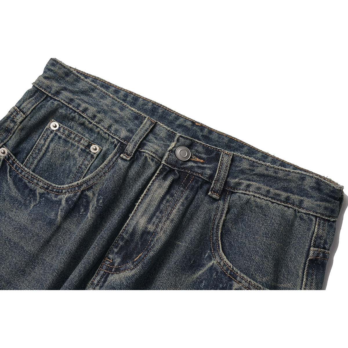 Close-up of the front waistband, button, and pockets of dark, heavily faded blue jeans.