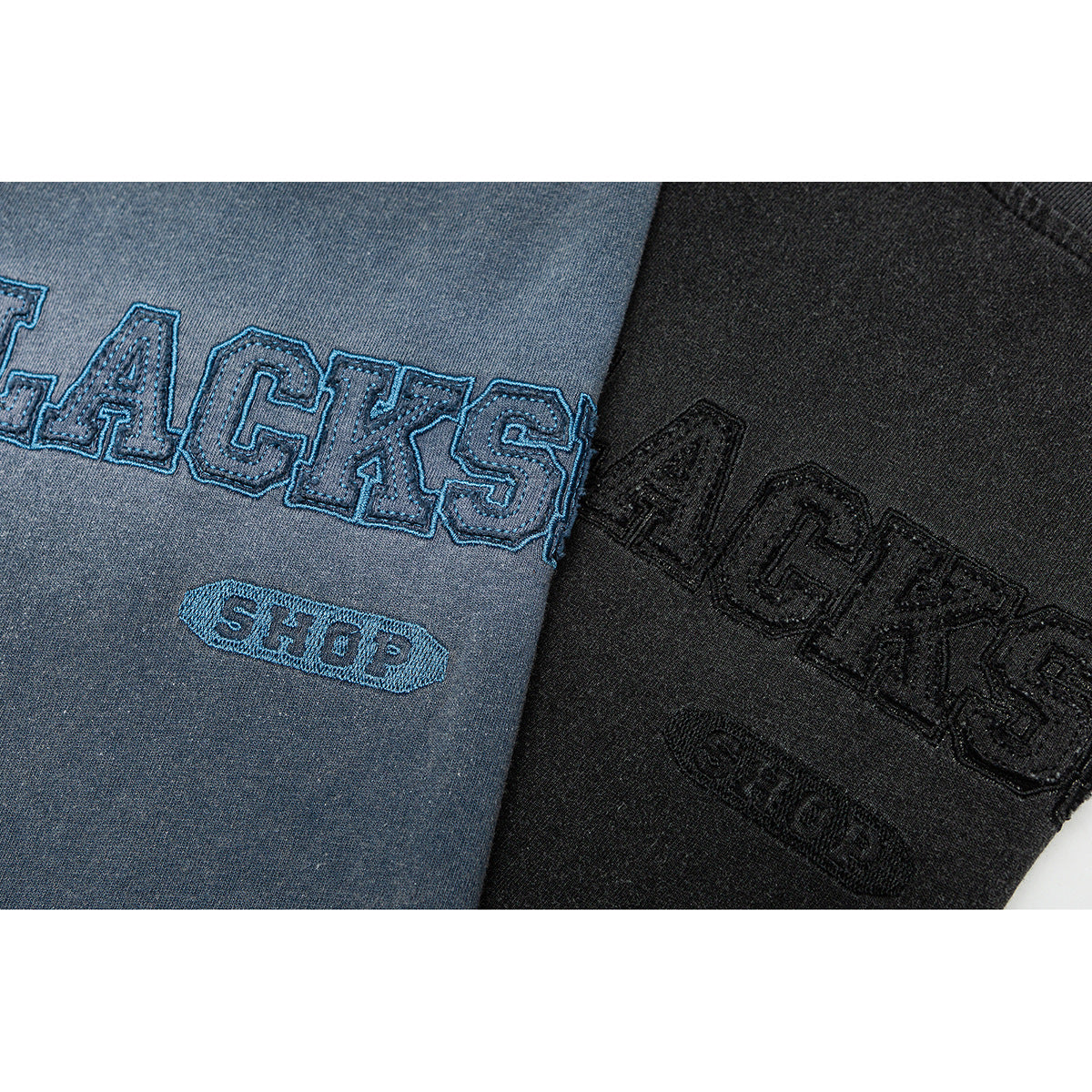 Close-up of embroidered lettering on faded blue and black T-shirts.