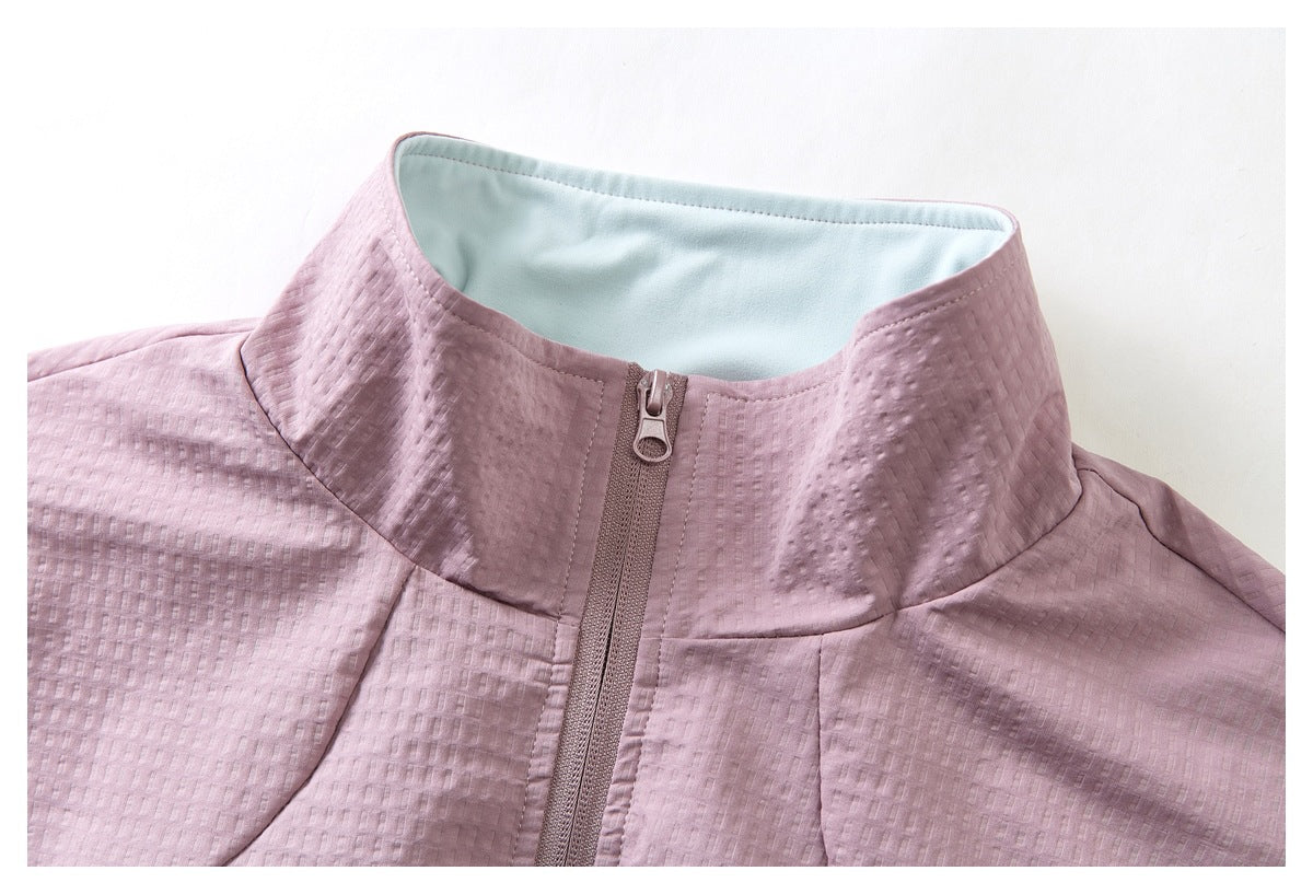 Close-up of the mauve jacket's stand collar, pale blue lining, textured fabric, and front zipper.