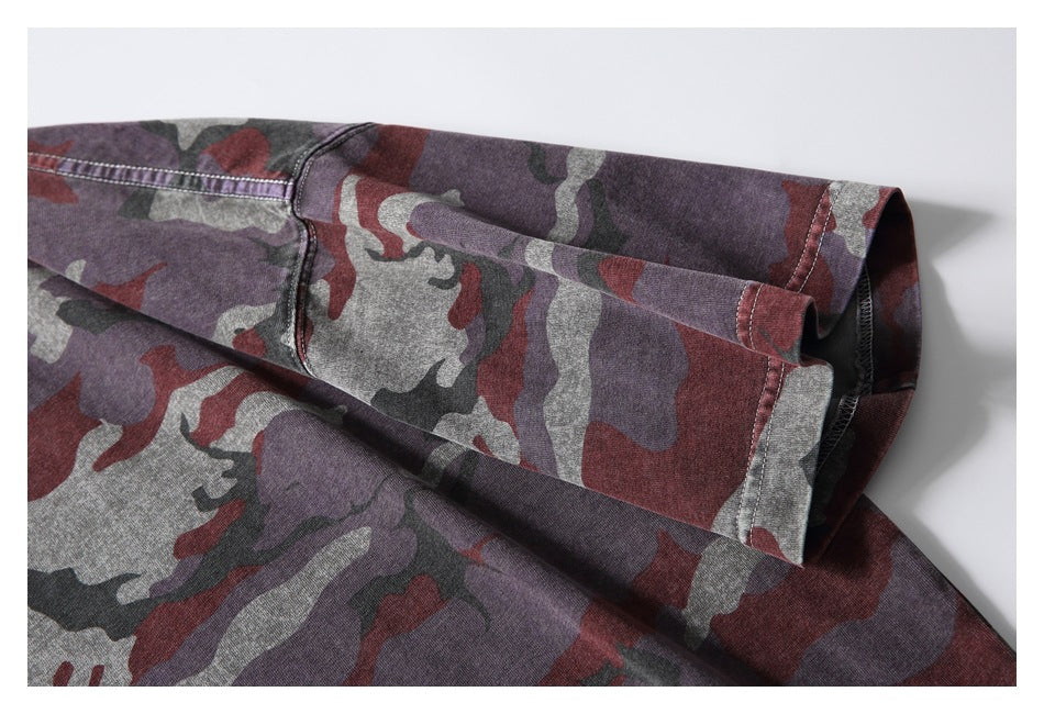 Close-up of the camouflage T-shirt's short sleeve, showing the cuff and stitching.