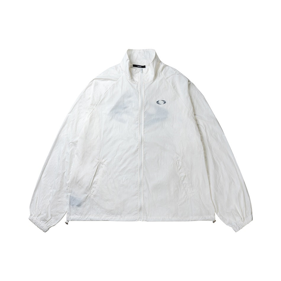 White zip-front jacket with a stand collar, elastic cuffs, angled pockets, and a small chest emblem, shown flat.