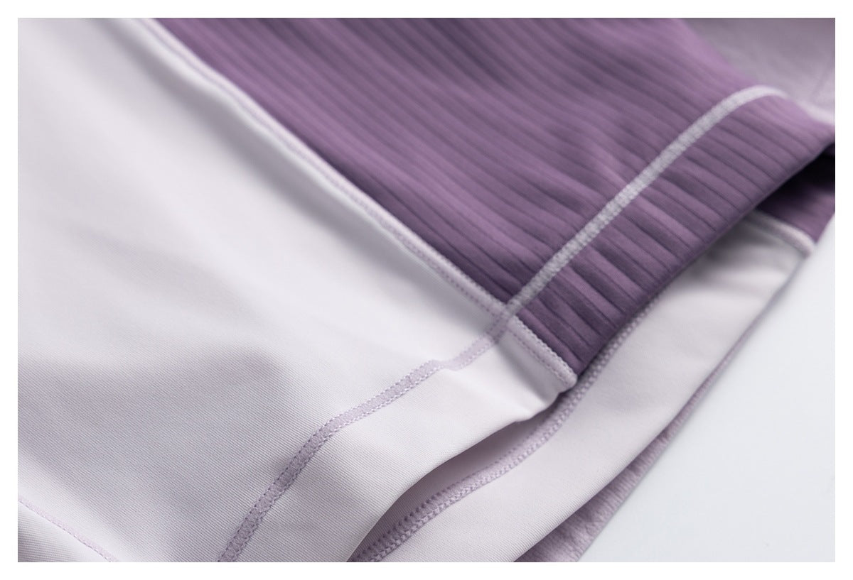 Close-up of the skort's inside with pale lavender stitching, a white lining panel, and a ribbed purple section.