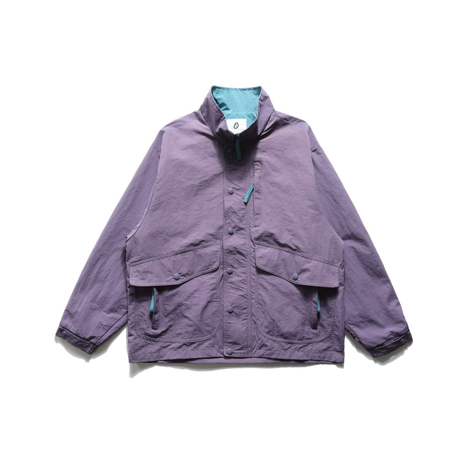 Light purple stand-collar nylon jacket, front flat lay, with teal collar lining, snap placket and large flap pockets