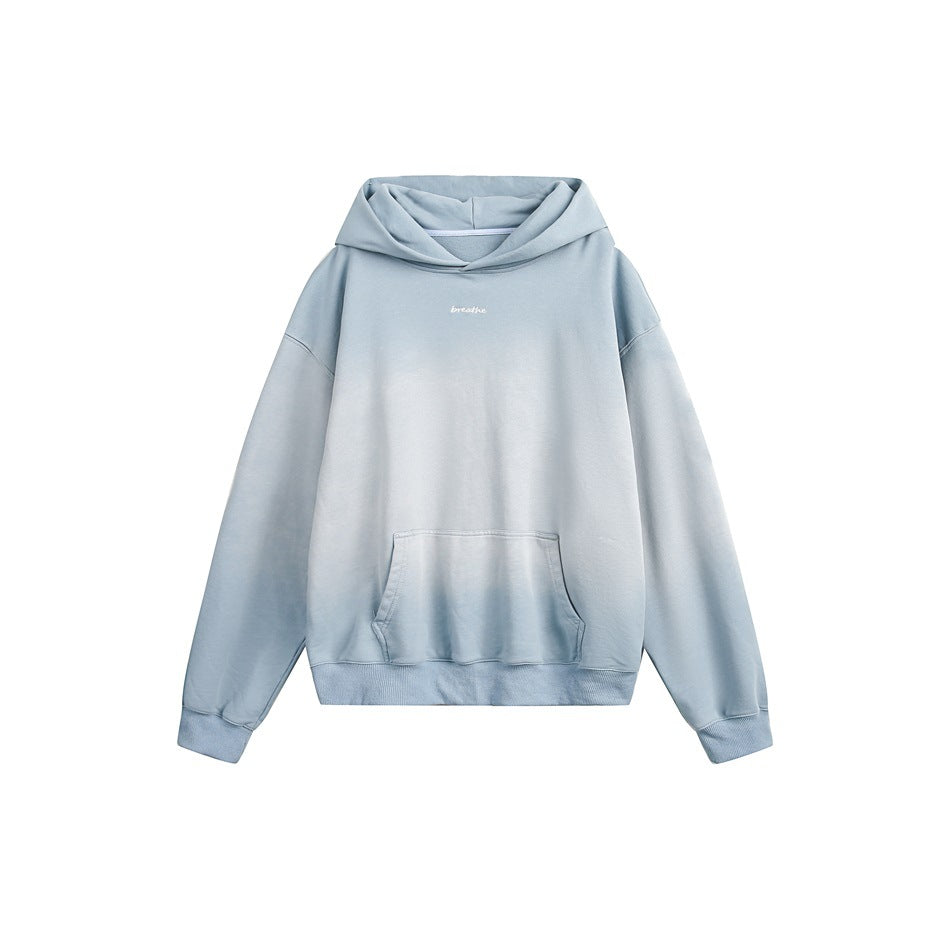 Washed light blue gradient pullover hoodie flat lay with kangaroo pocket and small white 'breathe' text on chest