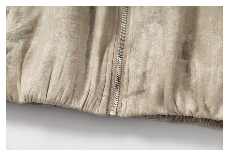 Close-up of the jacket's front zipper and gathered elastic hem.