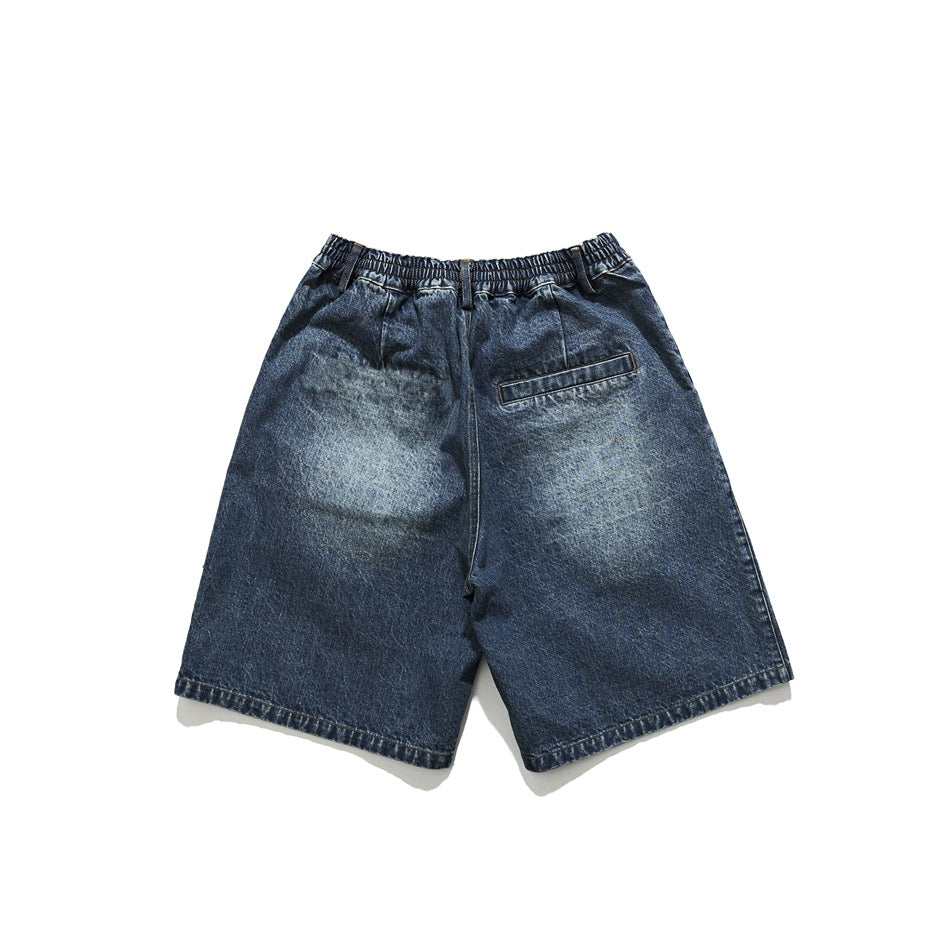 Back view of washed blue denim shorts with elastic waistband, back welt pocket and faded seat