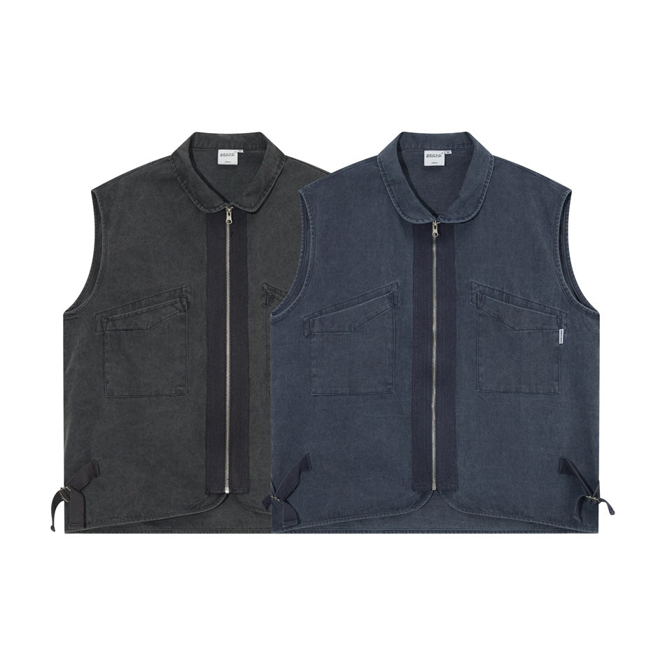 Two sleeveless zip-front vests shown from the front in charcoal and faded blue, each with a collar and chest pockets.