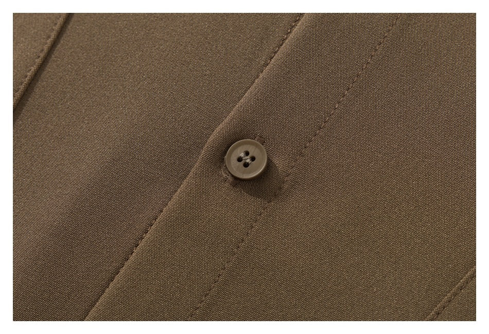 Close-up of a brown garment's stitched front placket and four-hole button.