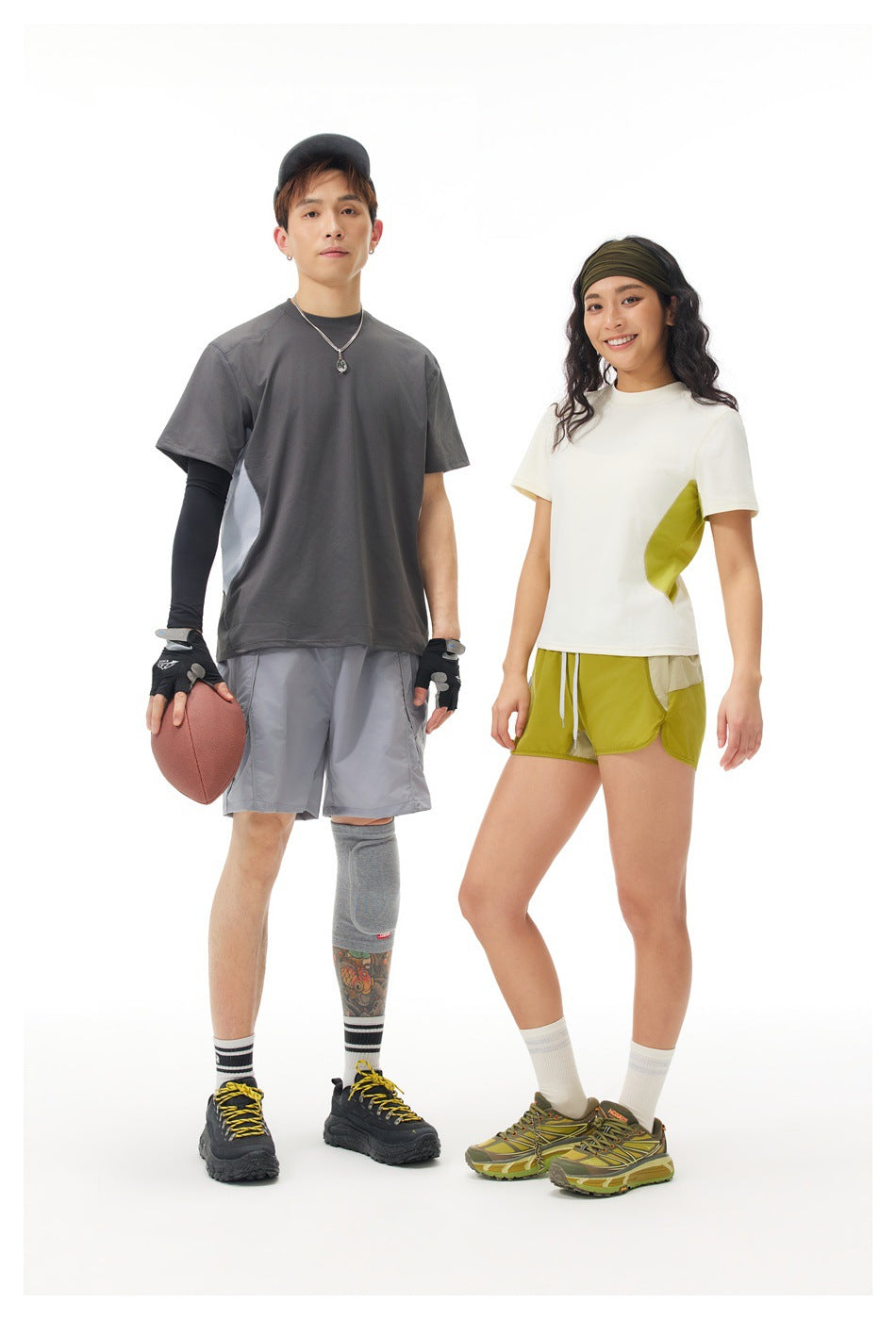Two models pose in sportswear; the man wears a charcoal and gray color-block shirt, and the woman wears a white and lime