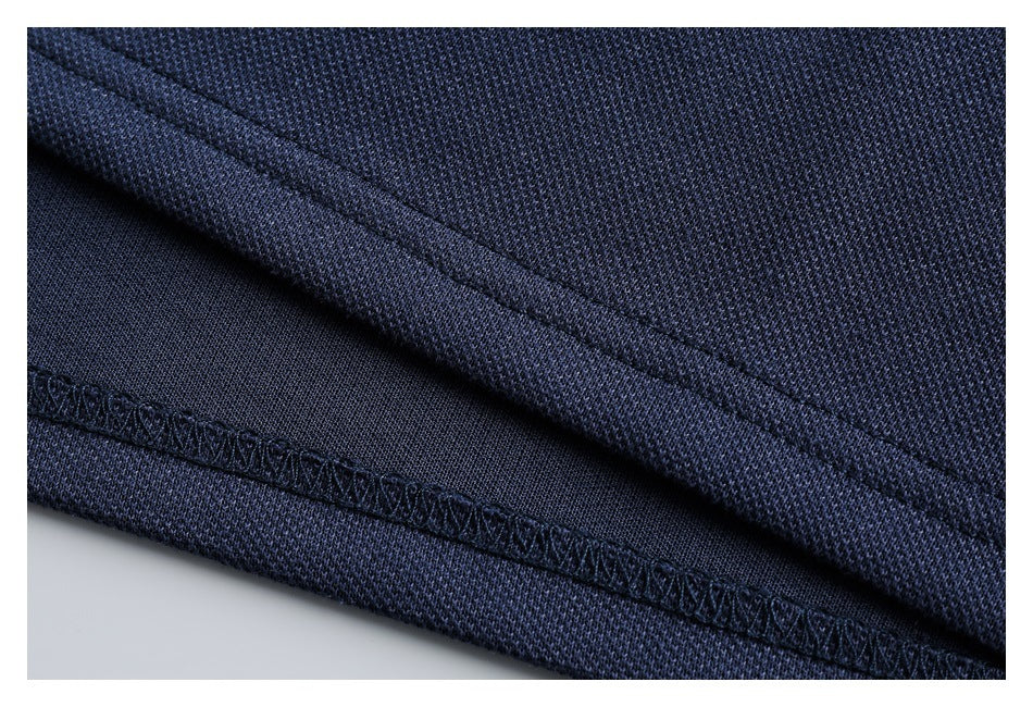 Close-up of navy polo fabric and finished seam stitching.