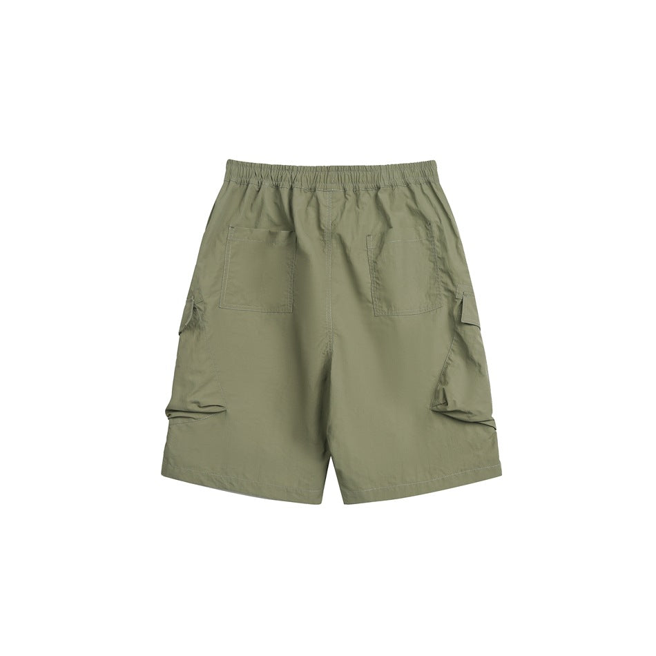 Rear view of olive green cargo shorts with an elastic waist, two back patch pockets and large side cargo pockets.