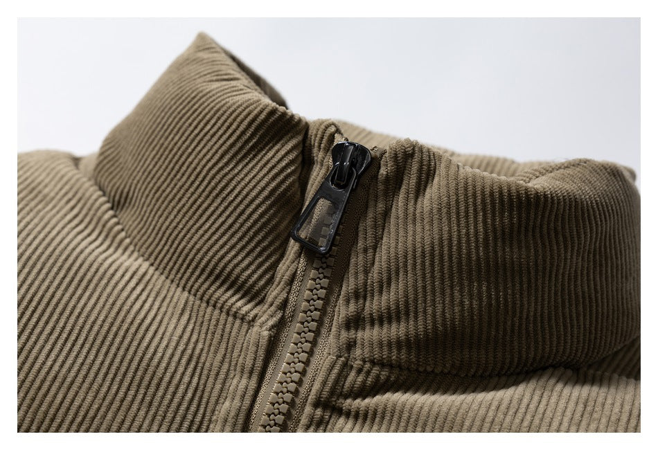 Close-up of a brown corduroy jacket's raised collar and front zipper.