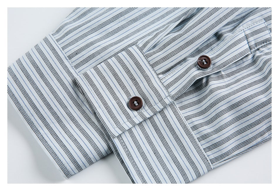 Close-up of a striped shirt cuff with two dark brown buttons and a button placket.