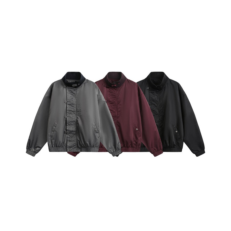 Three front-facing jackets in gray, burgundy, and black with stand collars, button fronts, and elastic cuffs and hems.