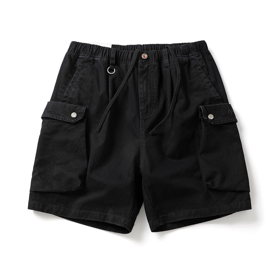 Black cargo shorts with elastic drawstring waist and large snap-flap cargo pockets, flat front view