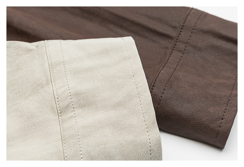 Close-up of light beige and dark brown shirt fabric and stitched cuff edges.