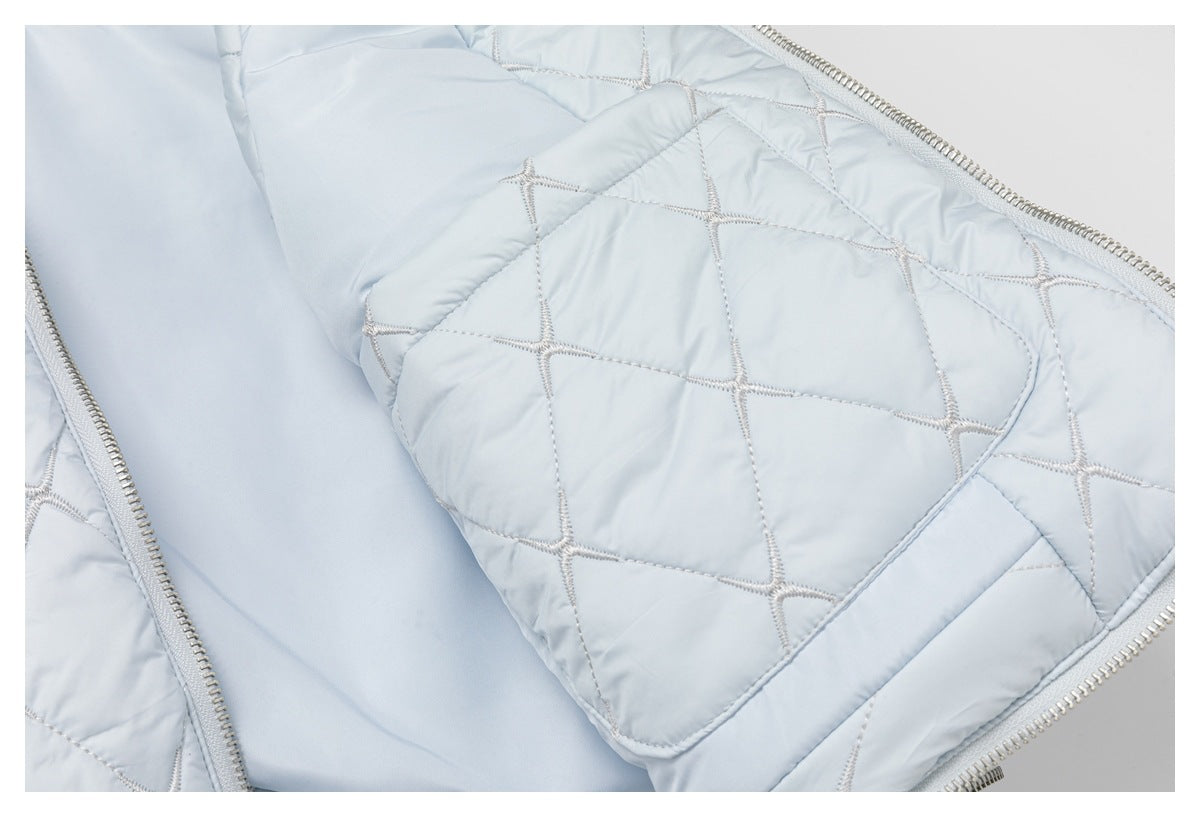 Open pale blue quilted garment showing its smooth lining and an interior patch pocket.