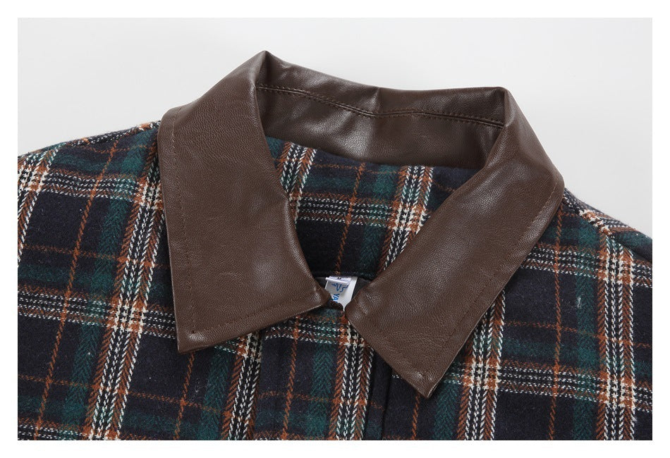 Close-up of a dark navy, green, and rust plaid garment with a wide brown collar.