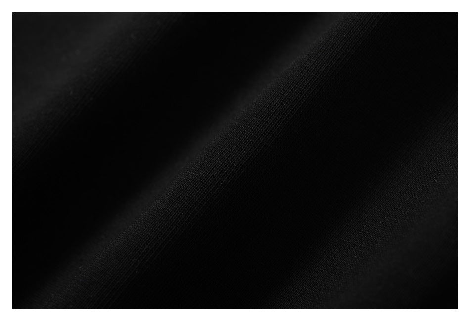 Extreme close-up of the black fabric's fine knit texture.