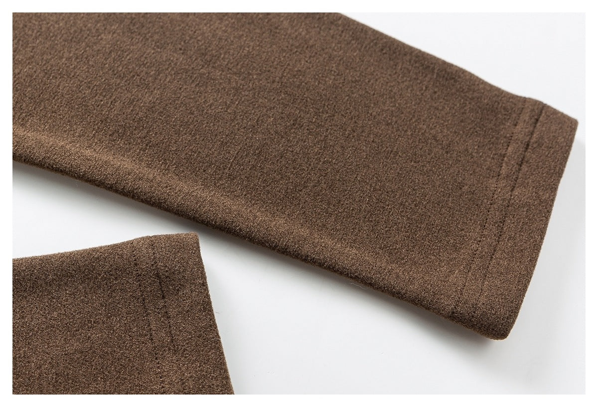 Close-up of a brown sleeve with a stitched cuff, with part of another garment section visible.