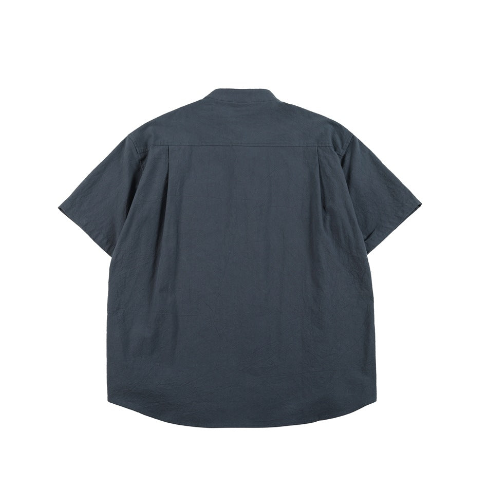 Back view of a slate-blue short-sleeve shirt with a stand collar and curved hem.