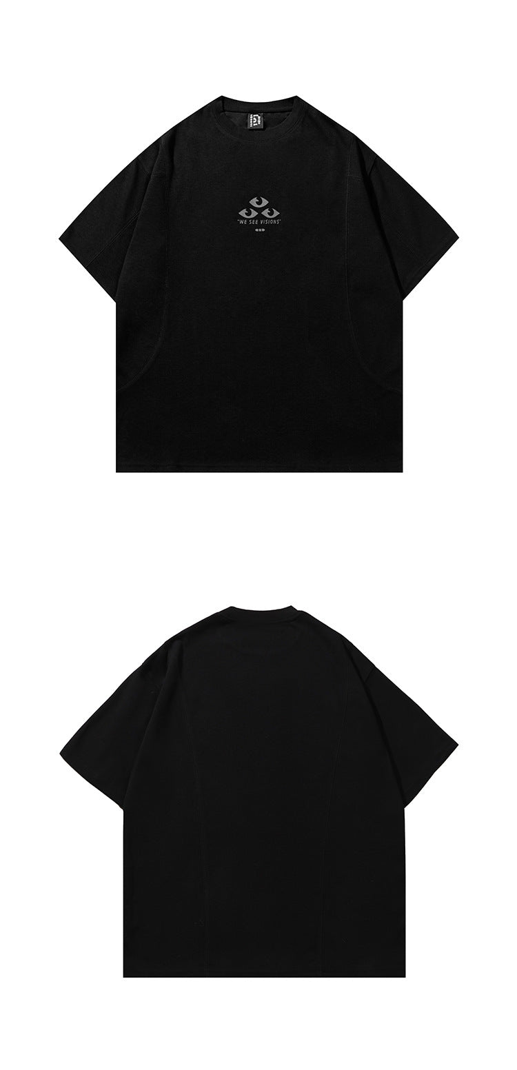 Front and back views of a black short-sleeve crew-neck T-shirt; the front has a small eye graphic and “WE SEE VISIONS” text.