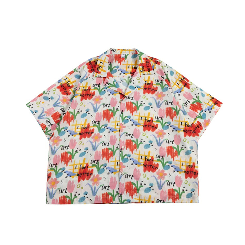 Flat-lay front of a short-sleeve camp-collar button shirt with colorful floral and 'art' hand-lettered print