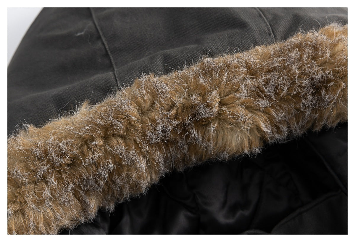 Extreme close-up of the jacket's tan and gray fur-trimmed hood edge against black lining.