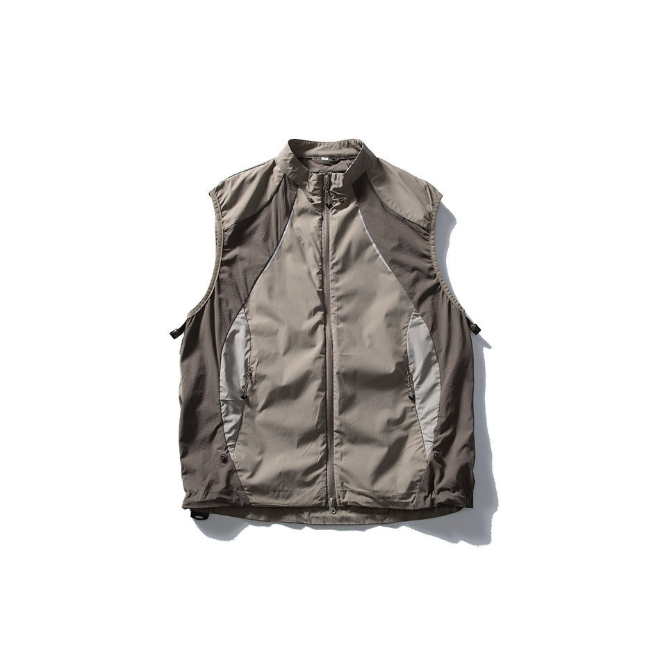 Taupe-gray sleeveless zip vest shown flat from the front, with a stand collar, contrast panels, and zip pockets.
