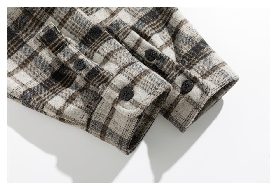Close-up of plaid cuffs with several dark buttons and buttonholes.