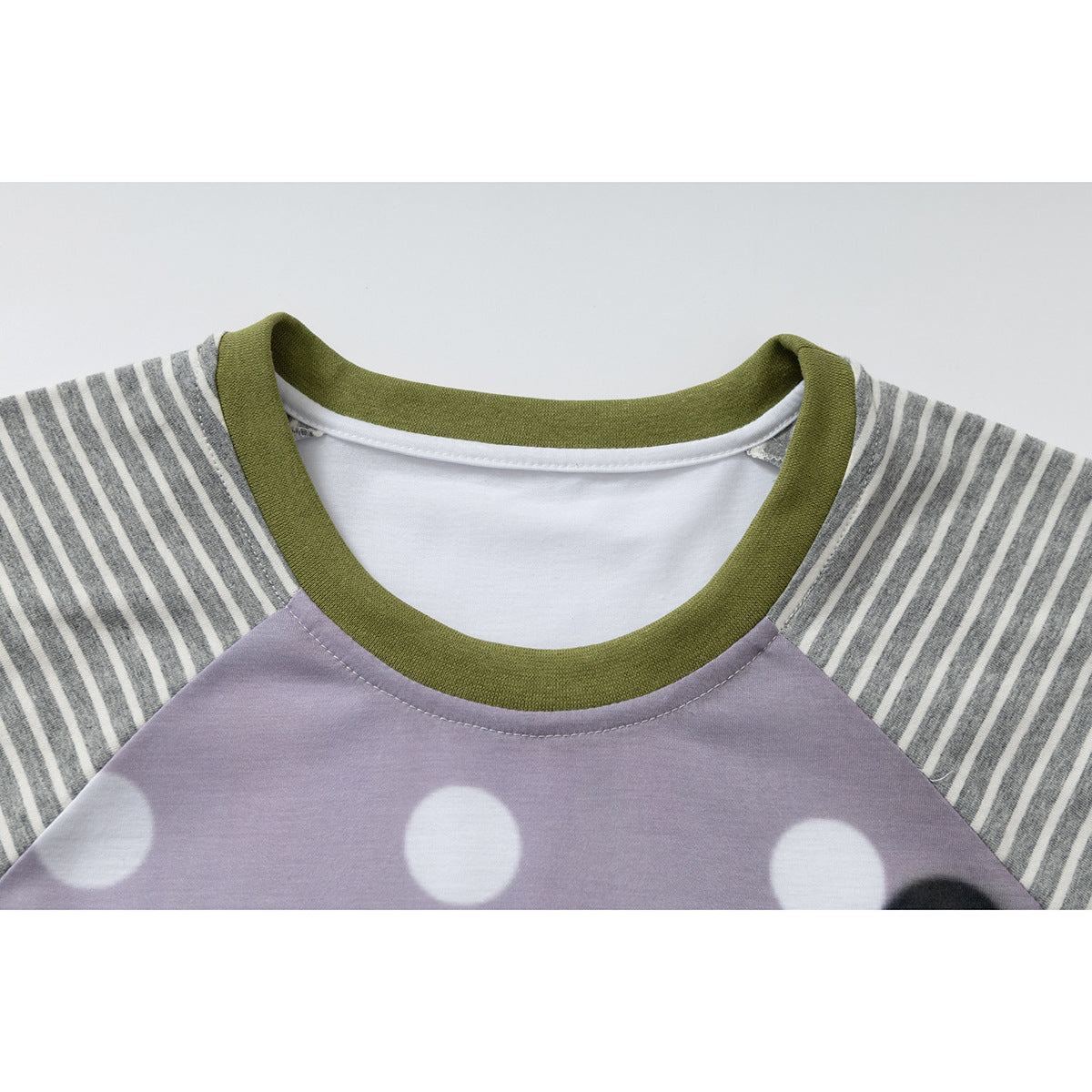 Close-up of a shirt neckline with an olive-green collar, gray striped raglan sleeves, and a lavender polka-dot front.