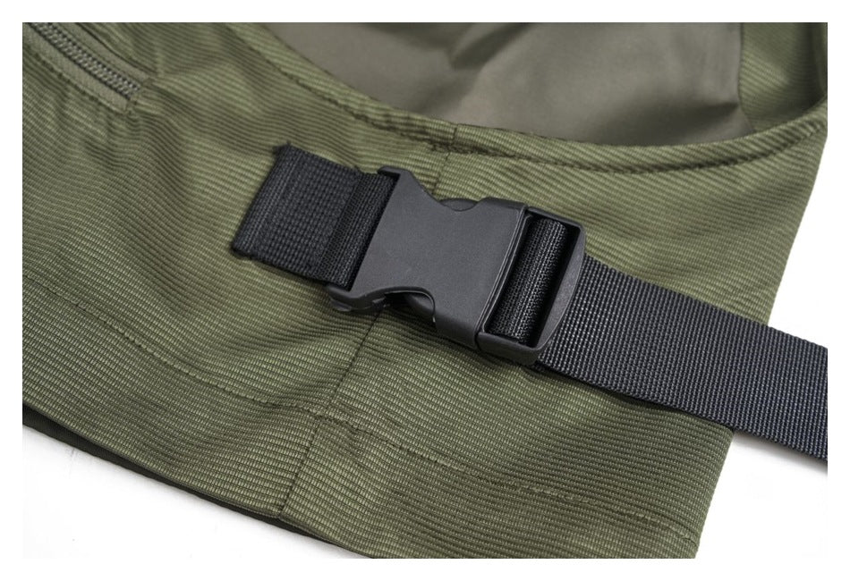 Close-up of the olive-green vest's black adjustable webbing strap and plastic buckle.